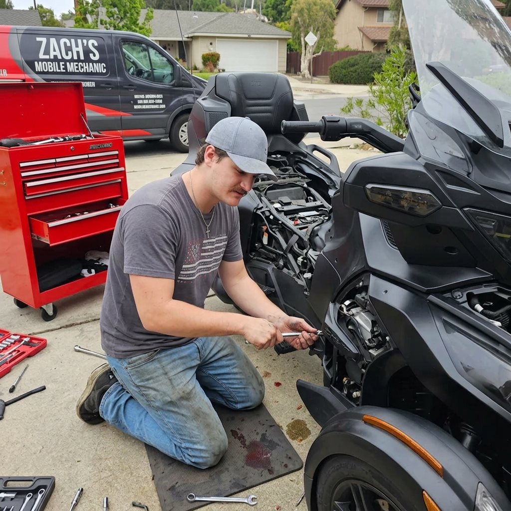 Zach Lahlum repairing a Can-Am Spyder RT in a San Diego driveway with his mobile service van